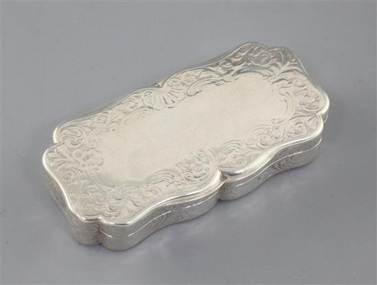 A Victorian engraved silver snuff box by Nathaniel Mills, of shaped rectangular form, gilt interior, Birmingham 1845, 9cm.